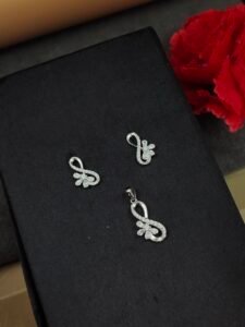 Elegant Floral Infinity Silver Pendant Set with matching infinity-inspired pendant and earrings featuring delicate floral accents on a black display stand.